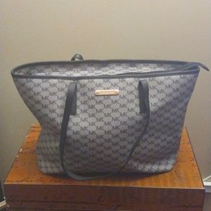 Large Authentic Micheal Kors travel carry on bag.